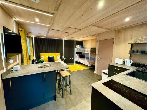 a kitchen with a blue island in a room at Stunning Secret Studio - Beach Retreat - Sleeps 4 in Bournemouth