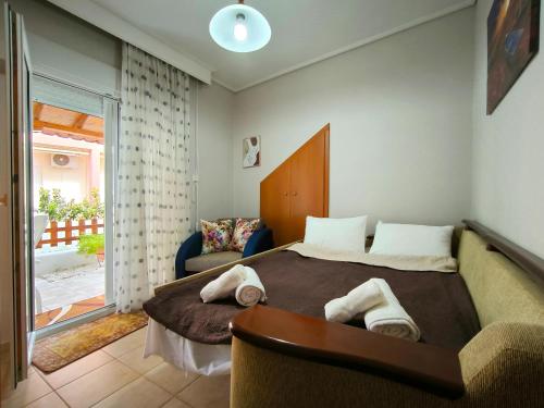 a bedroom with a large bed with towels on it at Simos Summer House in Fanari in Fanárion