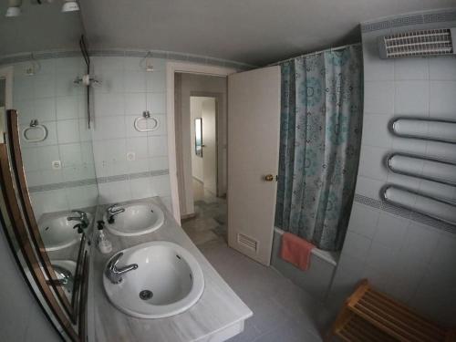 a bathroom with two sinks and a shower at Piso Feria de Abril in Fuengirola