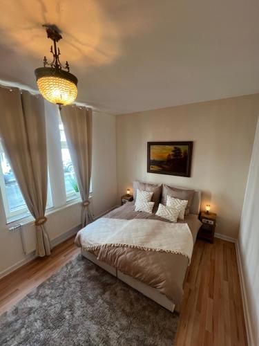 a bedroom with a bed and two windows at Ferienwohnung Nispel in Limburg an der Lahn