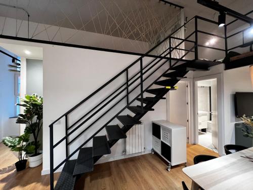 a black staircase in a living room with a ceiling at SG APARTAMENTOS, SILIÓ 4-B in Valladolid