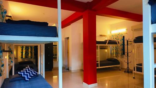 a bedroom with two bunk beds in a room at Mitra By The Pool in Vagator