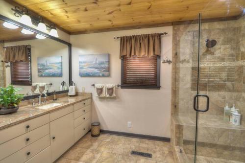 a bathroom with two sinks and a glass shower at 4 Seasons Lodge in Gatlinburg
