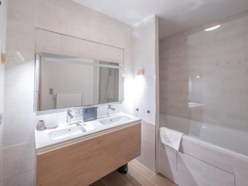a white bathroom with a sink and a mirror at Duplex neuf proche pistes avec Wifi et parking - FR-1-645-58 in LʼHuez