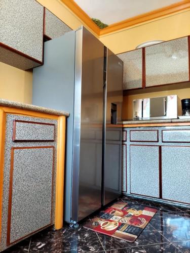 a large stainless steel refrigerator in a kitchen at Cas Bed and Breakfast in Corral Spring