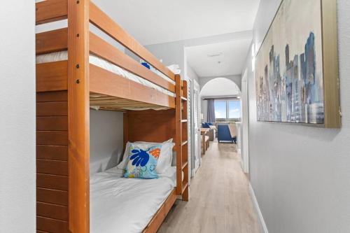 a room with two bunk beds and a hallway at Scenic View Condo Near Disney in Orlando