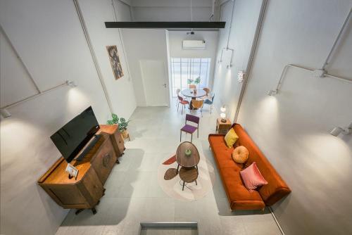 an overhead view of a living room with a couch and a table at Sukhumvit entire house 7 pax - 2 mins walk from skytrain in Bangkok
