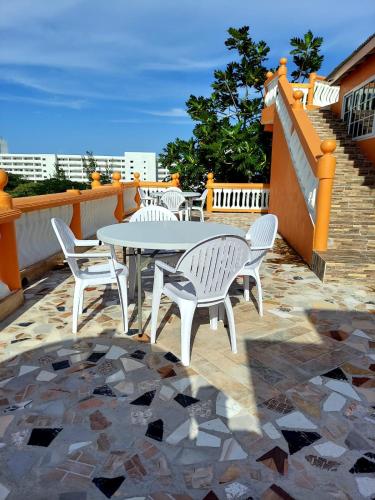 a patio with a table and chairs on a balcony at Cas Bed and Breakfast in Corral Spring