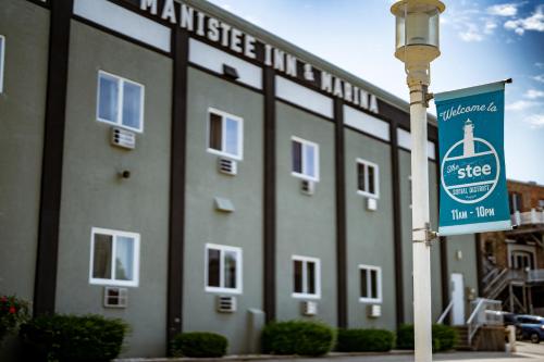 a building with a street sign in front of it at Manistee Inn & Marina in Manistee