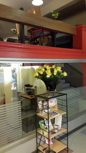 a vase of flowers on a shelf in a store at Hotel Amalfi in Asuncion