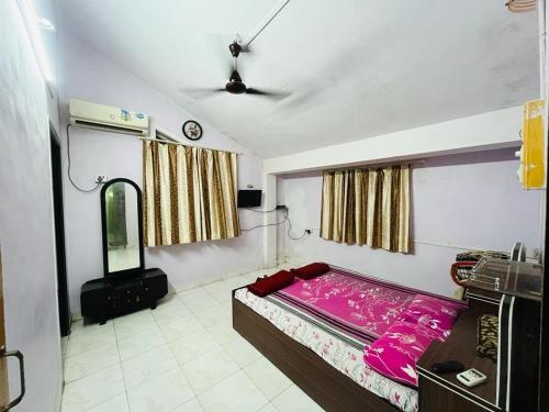 a bedroom with a bed and a mirror in it at Masum Villa in Nagaon
