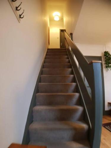 a staircase in a building with a light on the ceiling at The Cosy Home in Burton. Sleeps 5. Fast Wi-fi in Burton upon Trent