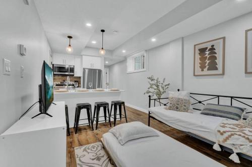 a living room with two beds and a kitchen at Stylish Suite-NearWEM-4 Bed-Central in Edmonton