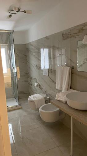 a bathroom with two sinks and a shower at Santa Lucia Affittacamere in Lamezia Terme
