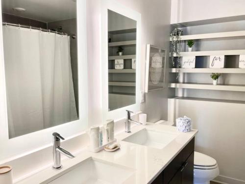 a white bathroom with a sink and a mirror at The Perfect Scenario in Buckhead in Atlanta