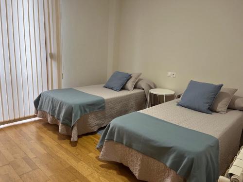 Cama o camas de una habitación en VIVE HOME Vilanova de Arousa