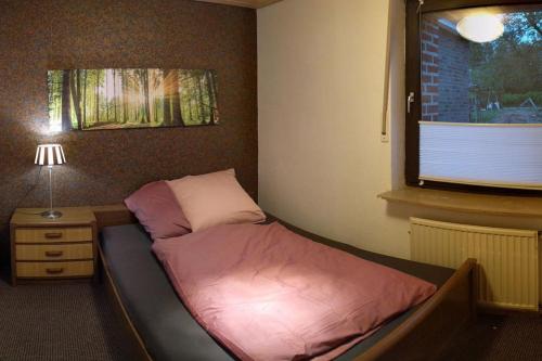 um pequeno quarto com uma cama e uma janela em NiBo Hof - Ruhig und verkehrsgünstig em Goch