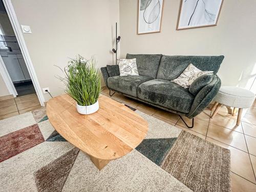 a living room with a couch and a table at La maison des Cordeliers in Loches