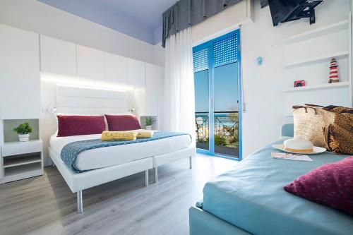 a bedroom with a bed and a view of the ocean at Hotel Eliseo in Bellaria-Igea Marina
