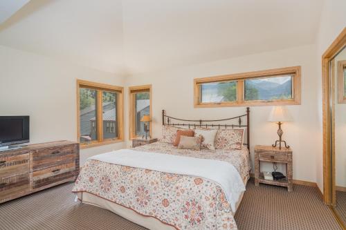 テルライドにあるAmazing View 2 Bed-2 Bath plus Loft Condo at Lulu Cityのベッドとテレビと窓のある寝室