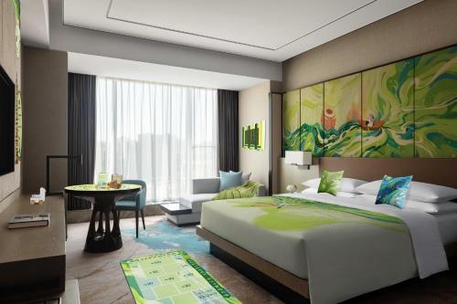 a bedroom with a large bed and a living room at Hangzhou Marriott Hotel Lin'an in Lin'an
