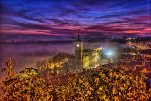 a city with a clock tower in the middle of a foggy city at La Madriguera de Toledo in Bargas