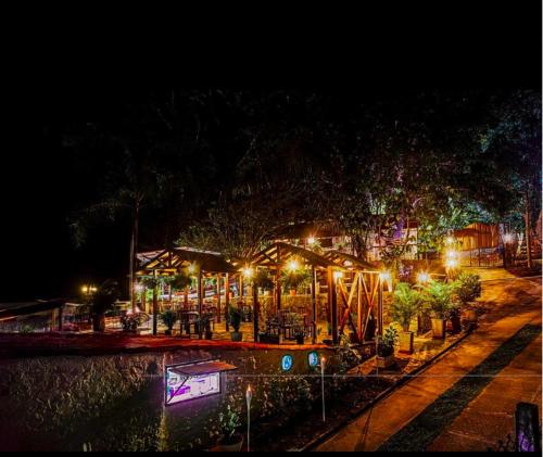 a park at night with lights and a playground at Casa Hotel Arcadia Minca in Minca
