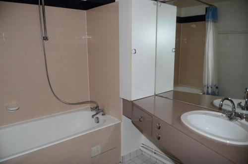 a bathroom with a sink and a shower and a tub at Résidence Belier - 2 Pièces pour 6 Personnes 74 in Flaine