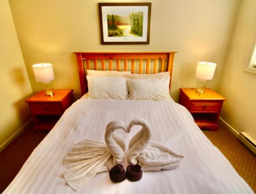 two swans making a heart on a bed at Timberline Condos - Aspen Building in Fernie