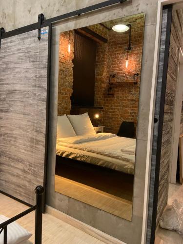 a room with a bed inside of a glass wall at Apartament w sercu miasta in Wrocław