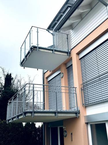 a balcony on the side of a building at Lakefront View Entire Apartment with 2 bedrooms, 2 full bathrooms & Balcony Waterview in Reichenau