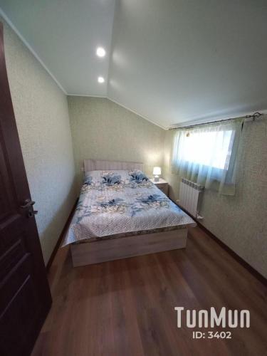 um quarto com uma cama e piso em madeira em Green guest house em Dilijan