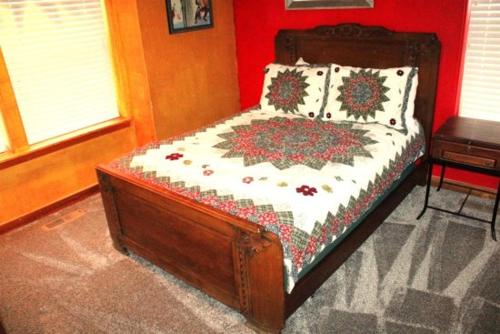 a bed in a room with a red wall at Hideaway Down Canyon #101 in June Lake