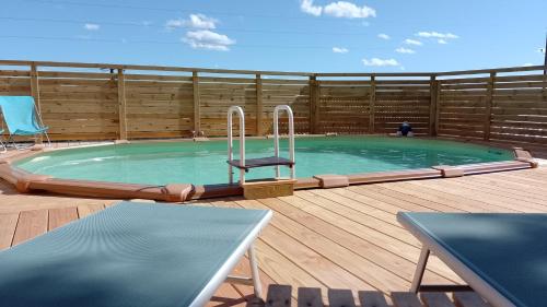 une piscine avec une chaise au milieu d'une terrasse dans l'établissement Lucinkas, à La Tour-sur-Orb