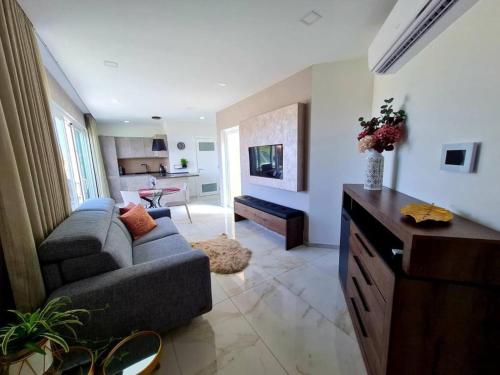 a living room with a couch and a table at Southridge PH with jacuzzi, TOP views by Homely in Mellieħa