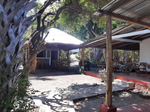 a patio with a white umbrella and tables and chairs at Playa Casa Nohelia in Santo Domingo