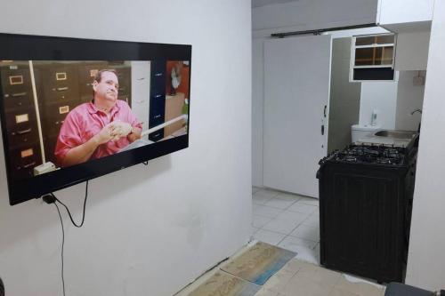 a television hanging on a wall in a kitchen at Cosy Corner #2 in Bridgetown