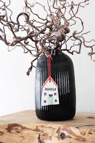 a black vase with a tag on it on a table at Newly refurbished home on the North Coast - AONB in Bushmills