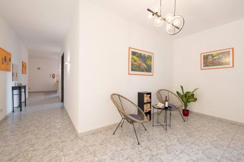 a living room with two chairs and a table at Villa Lorella - Private Pool, Jacuzzi By Homely in Mellieħa