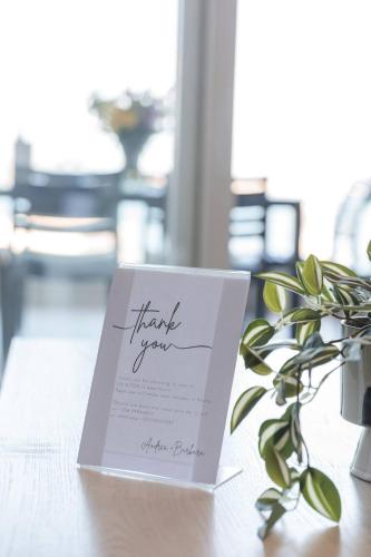 a thank you card sitting on a table with a plant at Luxe 3br Melliehabay Stunning Terrace By Homely in Mellieħa
