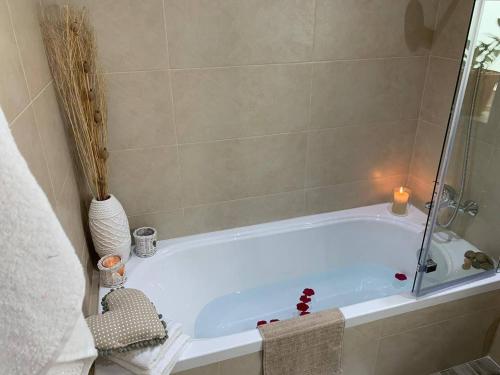 a bath tub with a candle in a bathroom at Ta'lonza Luxury Near Goldenbay With Hot Tub App3 in Mellieħa