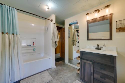 a bathroom with a tub and a sink and a shower at Bright Home with Outdoor Space, Steps to River in Indian River