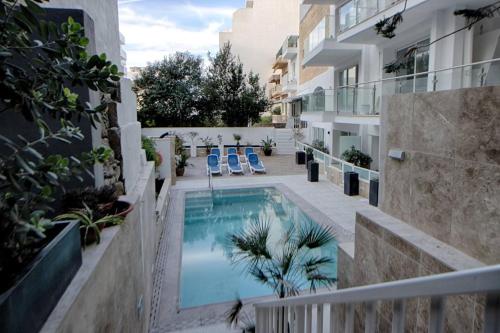 a swimming pool in the middle of a building at 3Bed Mellieha with shared heated pool by Homely in Mellieħa