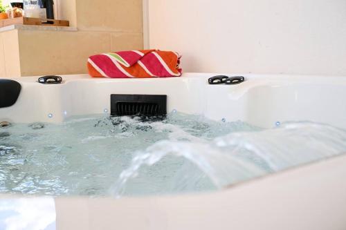 a bath tub filled with water with a pillow at Ta'lonza2 Prime Location Reach Most Of The Island in Mellieħa