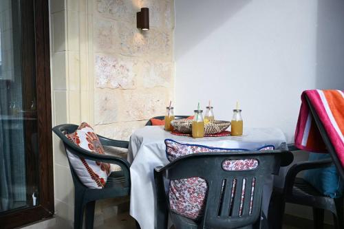 a table with two chairs with candles on it at Fl 2 Ta'lonza Luxury With Hot Tub By Homely in Mellieħa