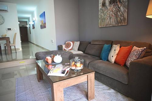 a living room with a couch and a coffee table at Fl 2 Ta'lonza Luxury With Hot Tub By Homely in Mellieħa