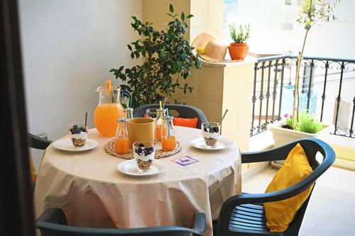 a table with plates of food on a balcony at Fl 2 Ta'lonza Luxury With Hot Tub By Homely in Mellieħa
