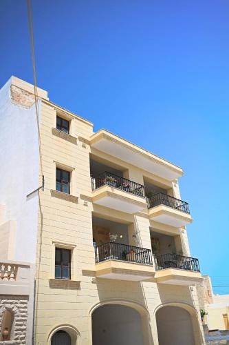 a tall building with balconies on the side of it at Fl 2 Ta'lonza Luxury With Hot Tub By Homely in Mellieħa