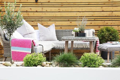 a patio with a couch and a table with plants at Newly refurbished home on the North Coast - AONB in Bushmills
