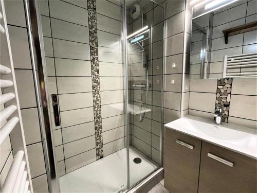 une salle de bain avec douche et lavabo dans l'établissement Résidence Bosson - Appartement 8 personnes ski aux pieds aux Ménuires MAE-3814, aux Menuires